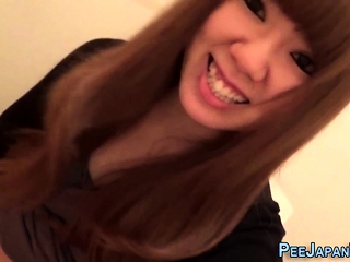 Asian pissing into toilet