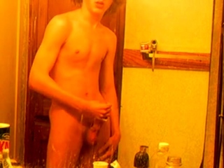 Curly-haired twink in bathroom