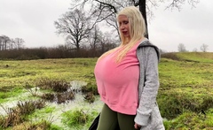 Blonde is flashing her big boobs in the outdoors