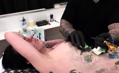 Marie Bossette gets a rose tattooed on her rib